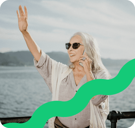 Person waving near the sea